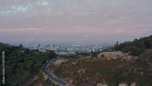 Flying Over Mountain Highways With City Center Of Cape Town During Sunset In South Africa. Aerial Drone Shot