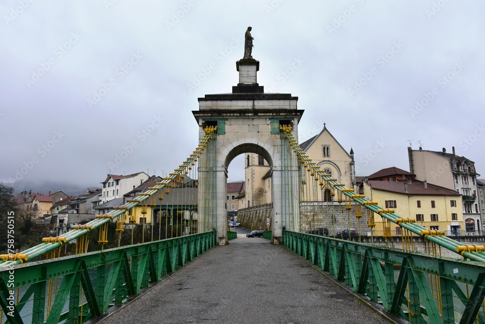 historic bridge over river Rhone in village Seyssel in France