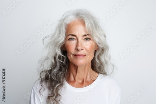 Portrait of beautiful senior woman with long grey hair looking at camera
