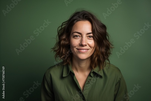 Portrait of a beautiful young woman with long wavy hair and green shirt