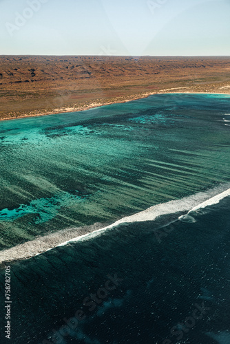 Scenic flight over the Ningaloo reef in Exmouth, Australia. Portrait aerial view of Cape range national park, the lagoon, the reef break and the ocean. Breathtaking point of view. Amazing experience.