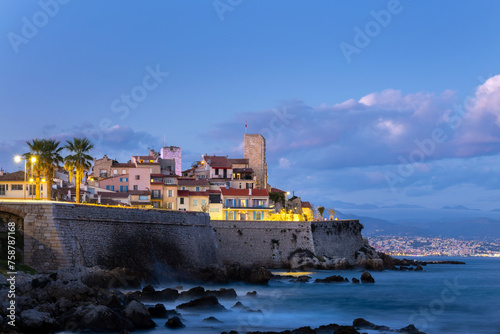 View of the rampart walls and the old town of Antibes at night on the French Riviera in the South of France