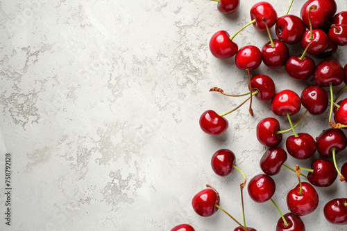 Fresh ripe cherries on light grey table, top view. Space for text