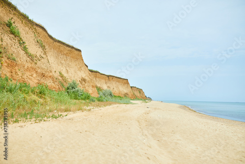 Serene Coastal Landscape With Cliffs and Sandy Beach on a Clear Day