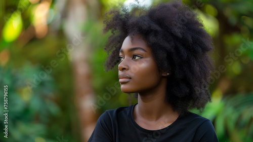A young African woman looking to the side in nature