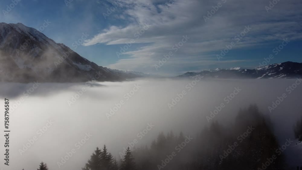 Drone ascending through a blanket of clouds to reveal the spectacular mountain ranges surrounding the Dachstein Drone ascending through a blanket of clouds to reveal the spectacular mountain ranges surrounding the Dachstein