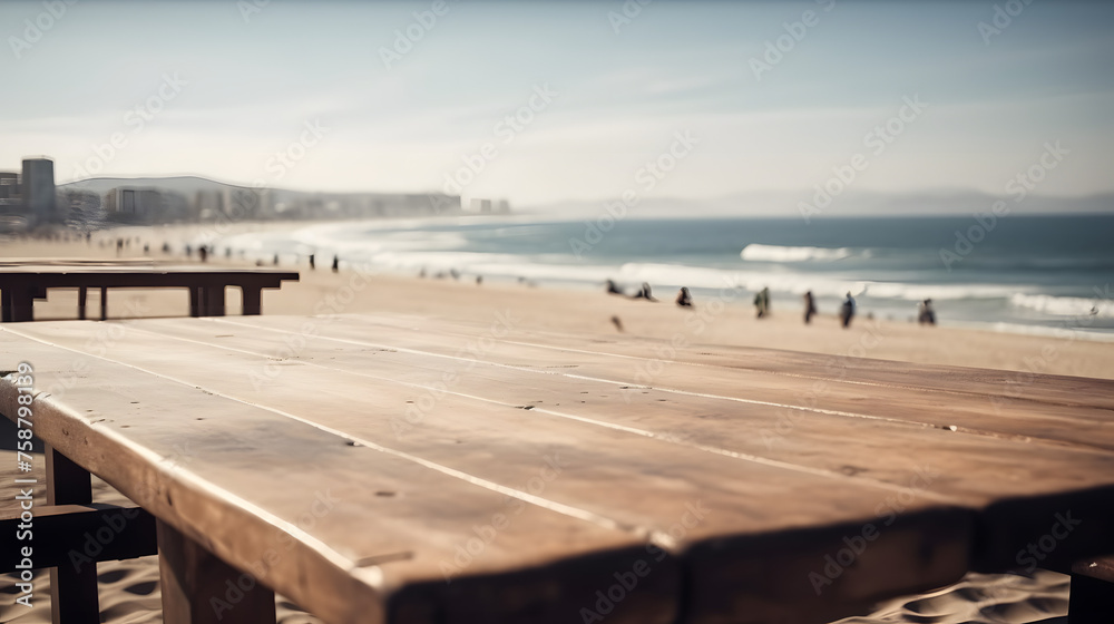 Empty wooden table in front of beach with people on background