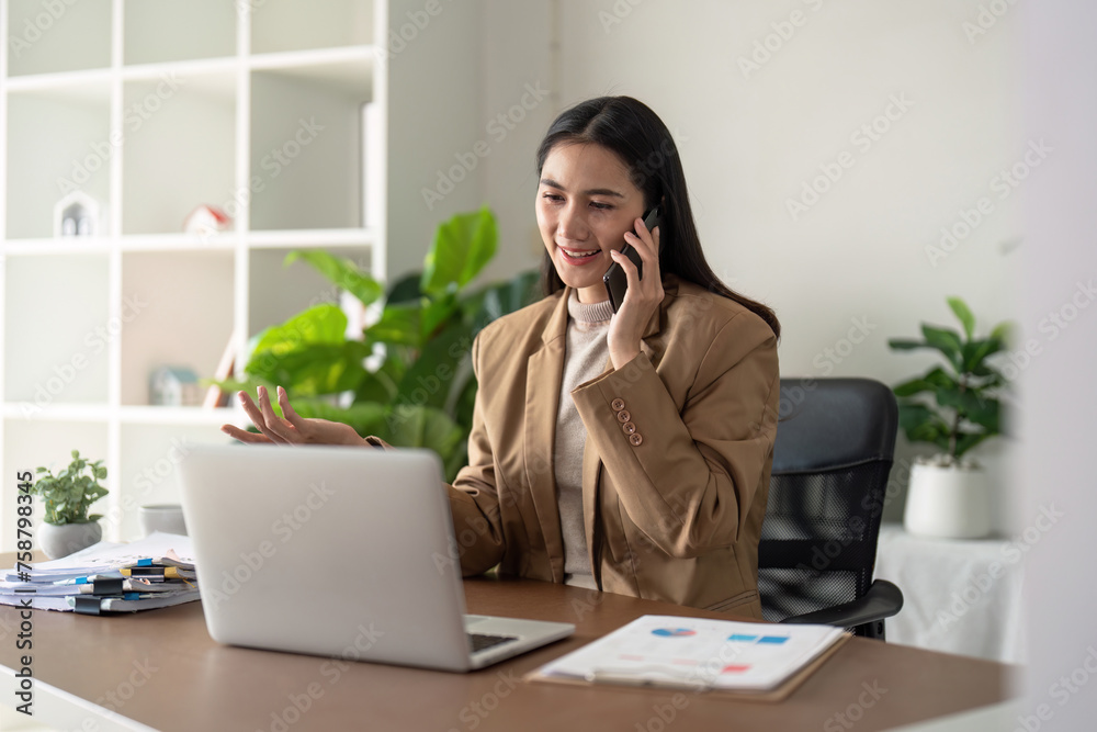 Work from home. Businesswoman using laptop computer and smartphone in her room. Eco friendly businesswoman working on desk, freelance, green room area, sustainable lifestyle concept Work from home. Businesswoman using laptop computer and smartphone in her room. Eco friendly businesswoman working on desk, freelance, green room area, sustainable lifestyle concept