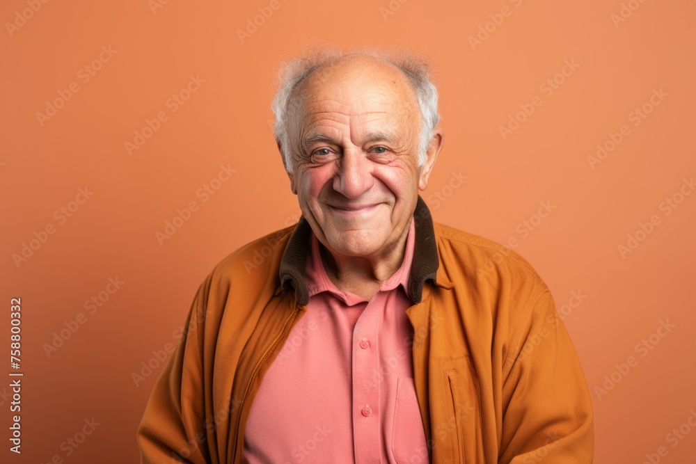 Elderly man in a orange shirt on a orange background. Elderly man in a orange shirt on a orange background.