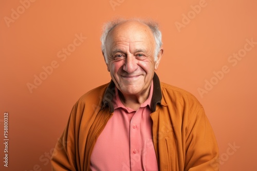 Elderly man in a orange shirt on a orange background. © Loli