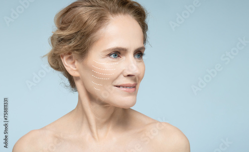 Portrait of beautiful mature woman with perfect skin of face, with arrows on face, concept of lifting skin