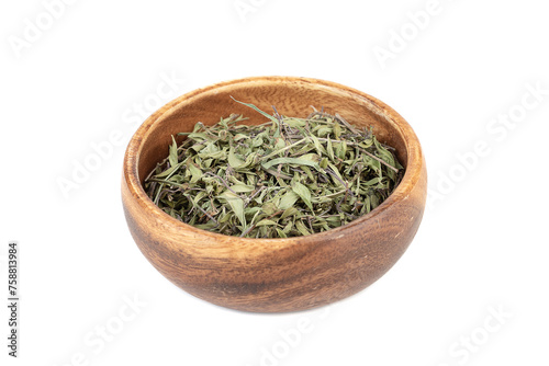 Dried thyme leaves in a wooden bowl over a white background.