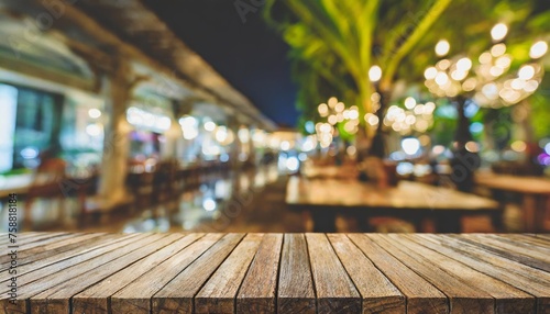 the empty wooden table top with blur background of restaurant at night exuberant image