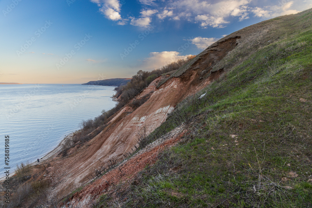 Stony, pebble and clay banks of the Volga River. Mountain slope of various stone rocks. Beautiful spring landscape view from above. Tetyushi, Tatarstan. Stony, pebble and clay banks of the Volga River. Mountain slope of various stone rocks. Beautiful spring landscape view from above. Tetyushi, Tatarstan.