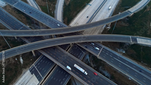 Traffic flows smoothly through strategically designed transport interchange. Witness optimization of traffic flows in action. Cinematic shot from drone efficiency of traffic flow optimization