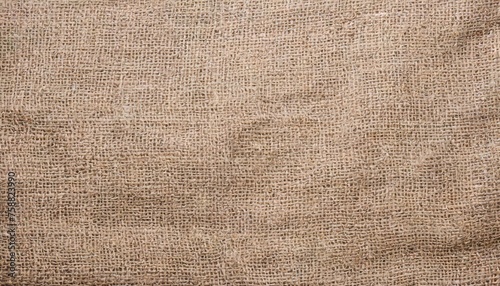 beige canvas texture background of cotton burlap natural fabric cloth in old aged brown