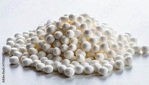 white plastic polymer pellets for the production of plastic products close up isolated on a white background