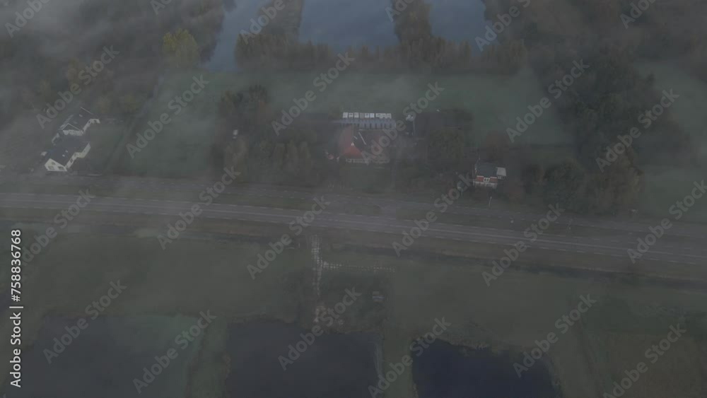 Aerial view of Dutch countryside with water and grassland during foggy morning, Friesland, Netherlands Aerial view of Dutch countryside with water and grassland during foggy morning, Friesland, Netherlands