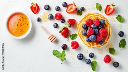 Homemade american pancakes with fresh berries, honey on white background, copy space included
