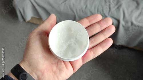 Man holding the cotton pad in his hand
