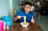 Korean,Japanese,Asian man eating Instant noodles very hot and spicy in local restaurant location.Food concept.