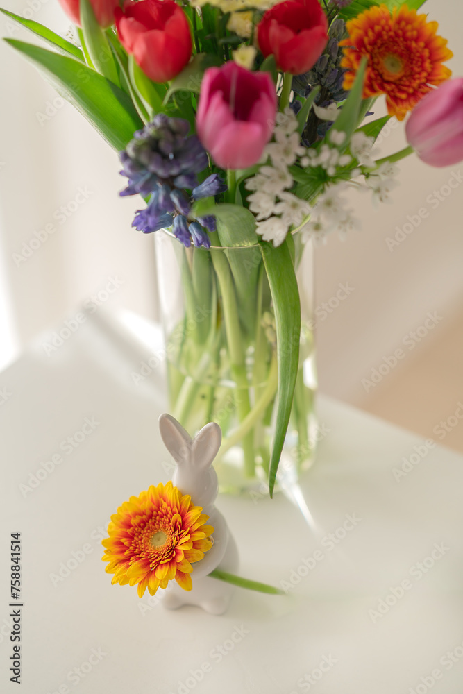 bouquet of flowers, Easter mood. Easter rabbit, rabbit with flower, spring sunny bouquet 
