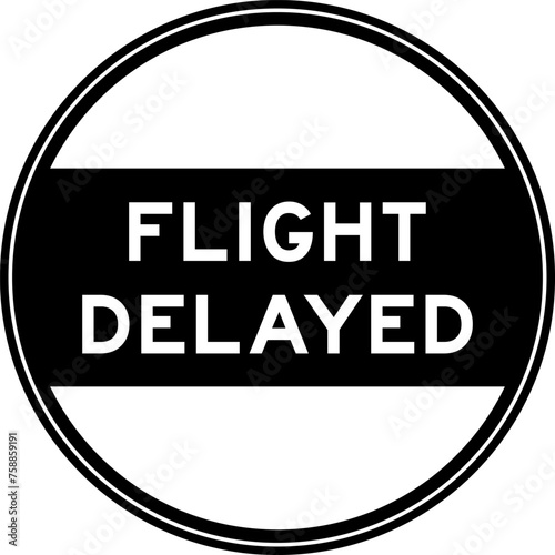 Black color round seal sticker in word flight delayed on white background