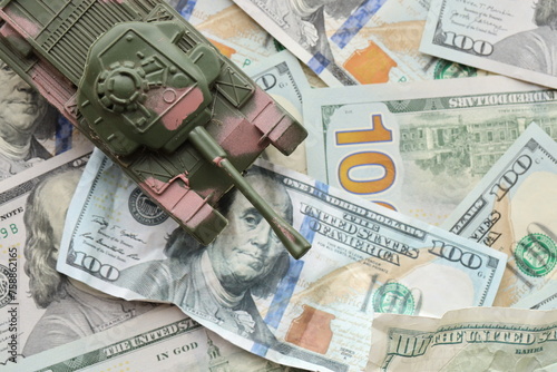 Tank on crumpled hundred dollar bills banknotes. Background of war funding and military support price for United States of America