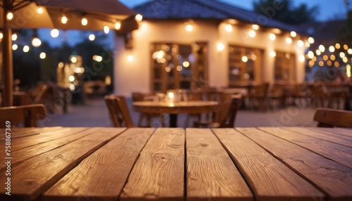 Empty wood table top on blur light gold bokeh of cafe restaurant in dark background