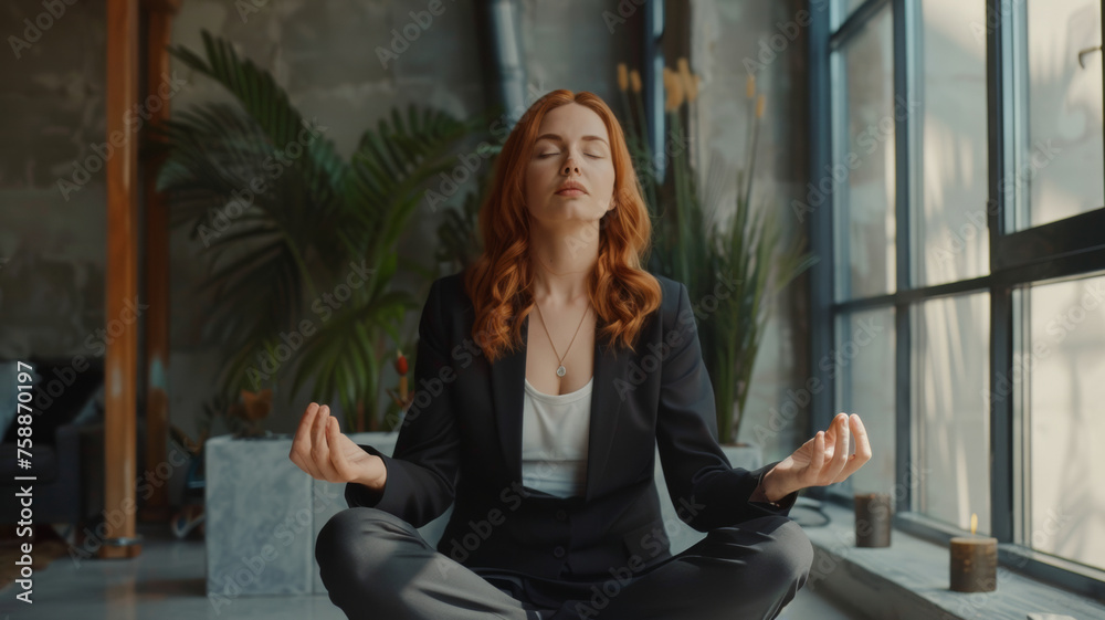 Woman in business attire meditating for mindfulness in a modern office.