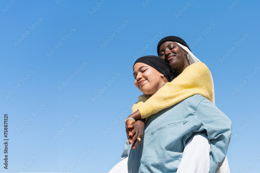 Two Gen Z young muslim women friends embracing with love and friendship Two Gen Z young muslim women friends embracing with love and friendship