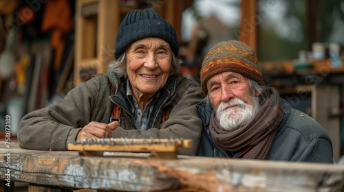 Senior couple smiling in a woodworking workshop.