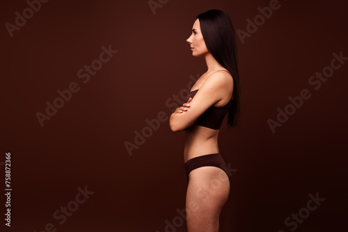 Profile photo of pretty sporty lady folded hands look empty space ad blank isolated on brown color background