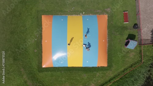 Aerial view of kids have fun and jumping on bouncing castle, Netherlands photo