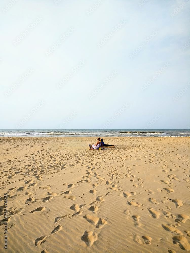 Obraz premium By the Ocean's Edge: Bonding Moments with Mother, Son and Dog