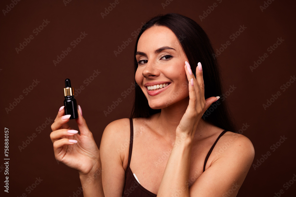 Photo portrait no retouch of pretty young girl bottle serum peeling touch soft skin wear trendy lingerie isolated on brown color background Photo portrait no retouch of pretty young girl bottle serum peeling touch soft skin wear trendy lingerie isolated on brown color background