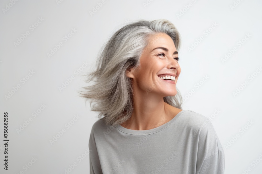 Portrait of a happy senior woman with grey hair on white background Portrait of a happy senior woman with grey hair on white background