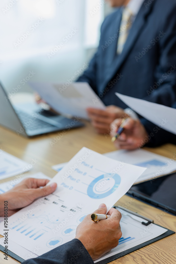 Meeting in the office Teamwork with cost analysis graph, business people on table at conference room Meeting in the office Teamwork with cost analysis graph, business people on table at conference room