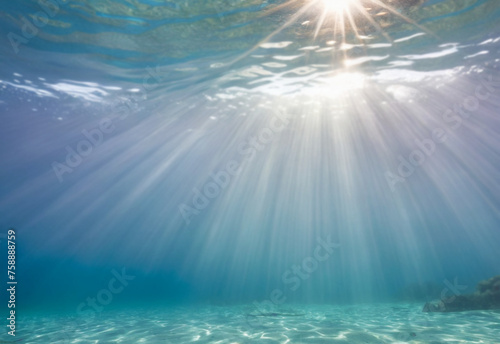 View underwater with bright rays of sun from above, seabed for diving.