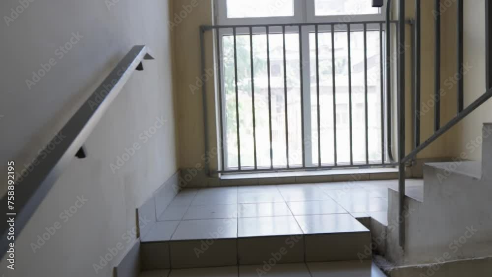 POV video. A man climbs the stairs in the stairwell. A typical staircase of an apartment building. POV video. A man climbs the stairs in the stairwell. A typical staircase of an apartment building.