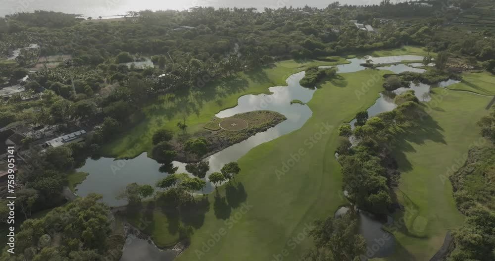 Aerial view of Constance Golf Course with lush greens and beautiful lake, Pointe de Flacq, Mauritius. Aerial view of Constance Golf Course with lush greens and beautiful lake, Pointe de Flacq, Mauritius.