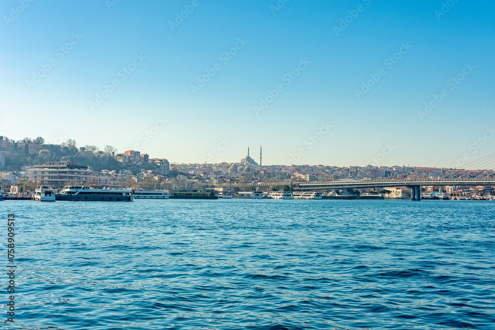 Landscape of Istanbul city with bridge and sea boats.