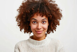 Joyful woman with curly hair on white background