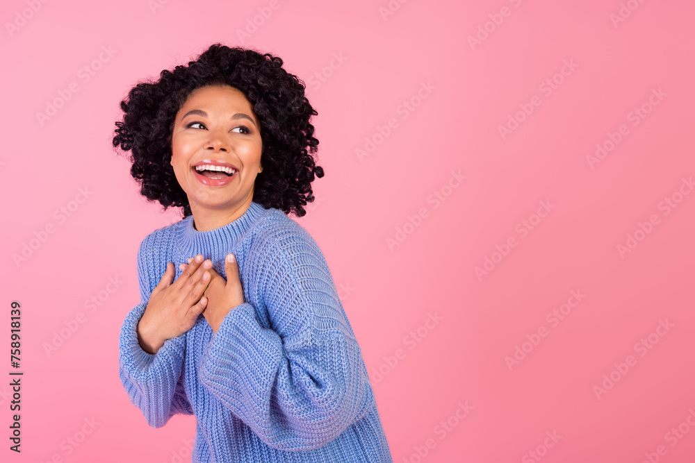 Photo portrait of lovely young lady touched grateful look empty space wear trendy blue knitwear garment isolated on pink color background Photo portrait of lovely young lady touched grateful look empty space wear trendy blue knitwear garment isolated on pink color background
