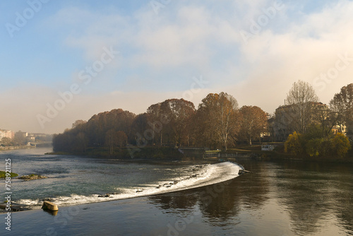 View of the Po River with the Ignazio Michelotti river park and the Regina Margherita Bridge in the background in autumn, Turin, Piedmont, Italy photo