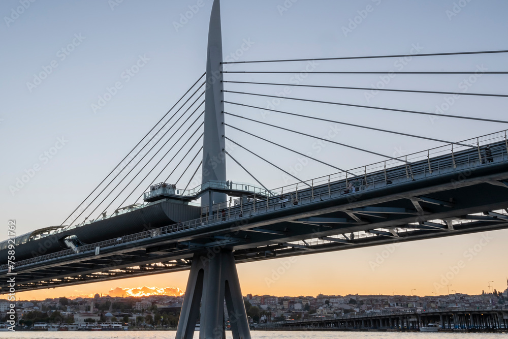 metro bridge located on the golden horn of istanbul golden horn with sunset light buildings and balat district in the background metro bridge located on the golden horn of istanbul golden horn with sunset light buildings and balat district in the background