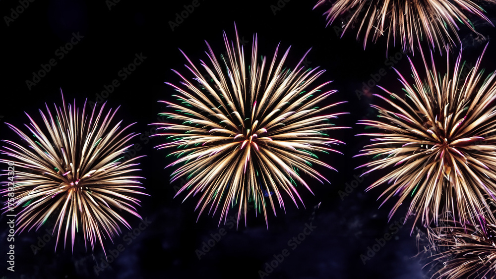 Fireworks in the night sky. Colorful celebration fireworks isolated on a black sky background