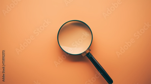 An antique magnifying glass placed on a pastel background