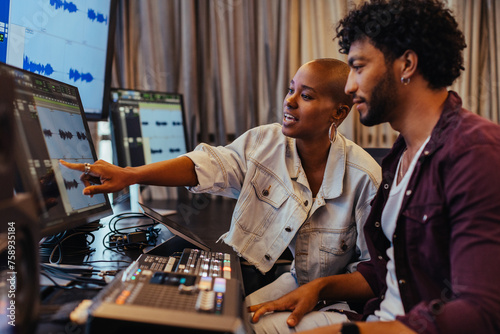 Creative professionals collaborating in a music studio with modern equipment
