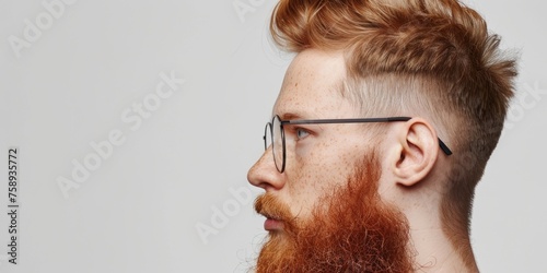 A man with a red beard and glasses, suitable for business or casual concepts photo